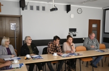 grupa osób siedzaca przy stole
