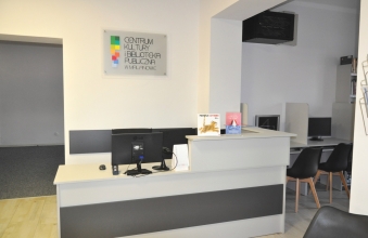 kremowe biurko w tle logotyp centrum kultury i biblioteki publicznej w malanowie