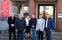 grupa osob stojaca przed budynkiem urzedu gminy